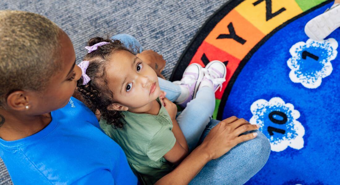 Behavior therapist with patient working at a rug for Circle Time