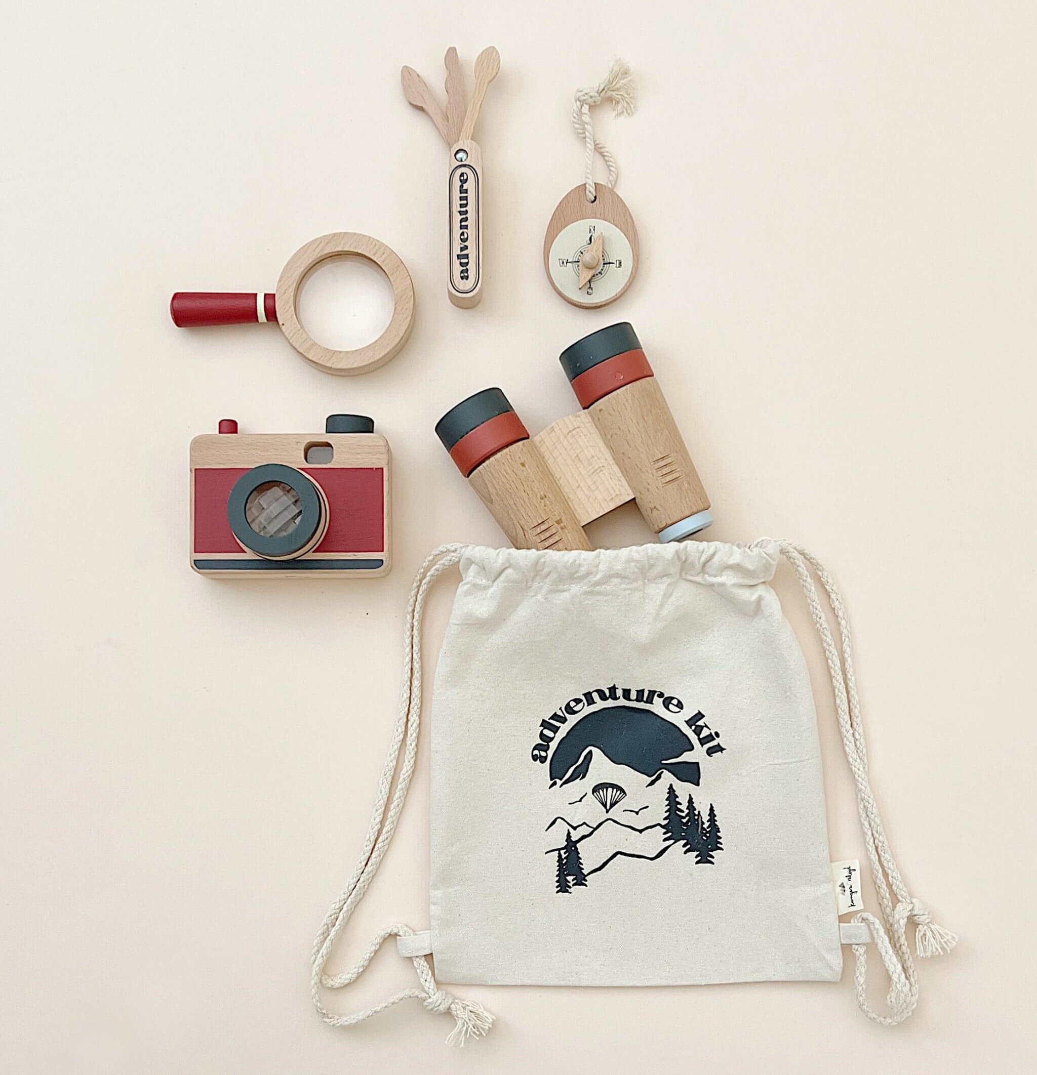 Odin Parker Wooden Explorer Kit with a toy camera, compass, binoculars, magnifying glass and bag.