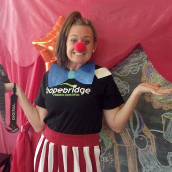Taylor working at Hopebridge dressed as a silly clown.