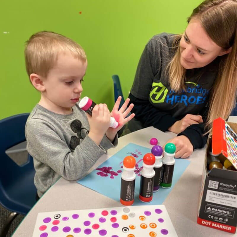 Boy using dot marker as part of ABA therapy at Hopebridge.