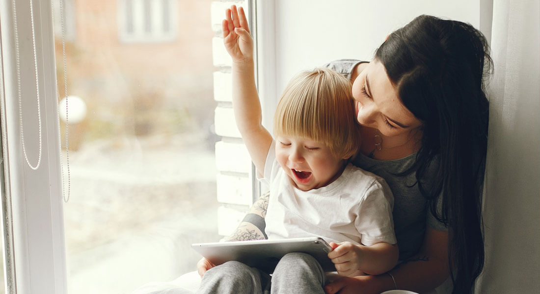 mom sitting with autistic son looking for therapy resources