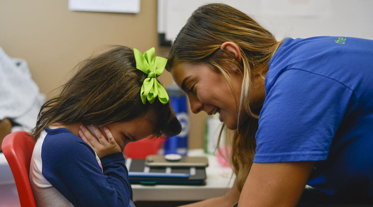 ABA therapist working with a child as part of therapy for autism.