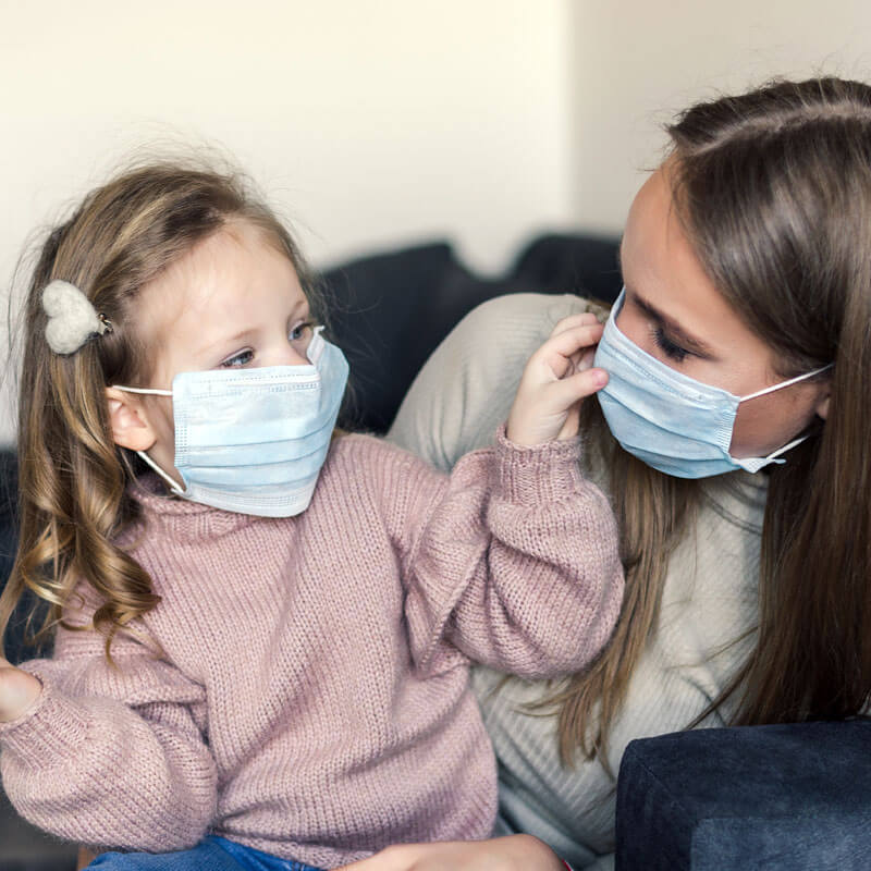 GIrl with autism wearing a mask with mom