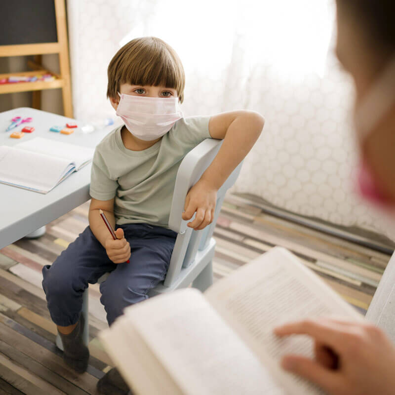 Kid on the spectrum wearing face mask