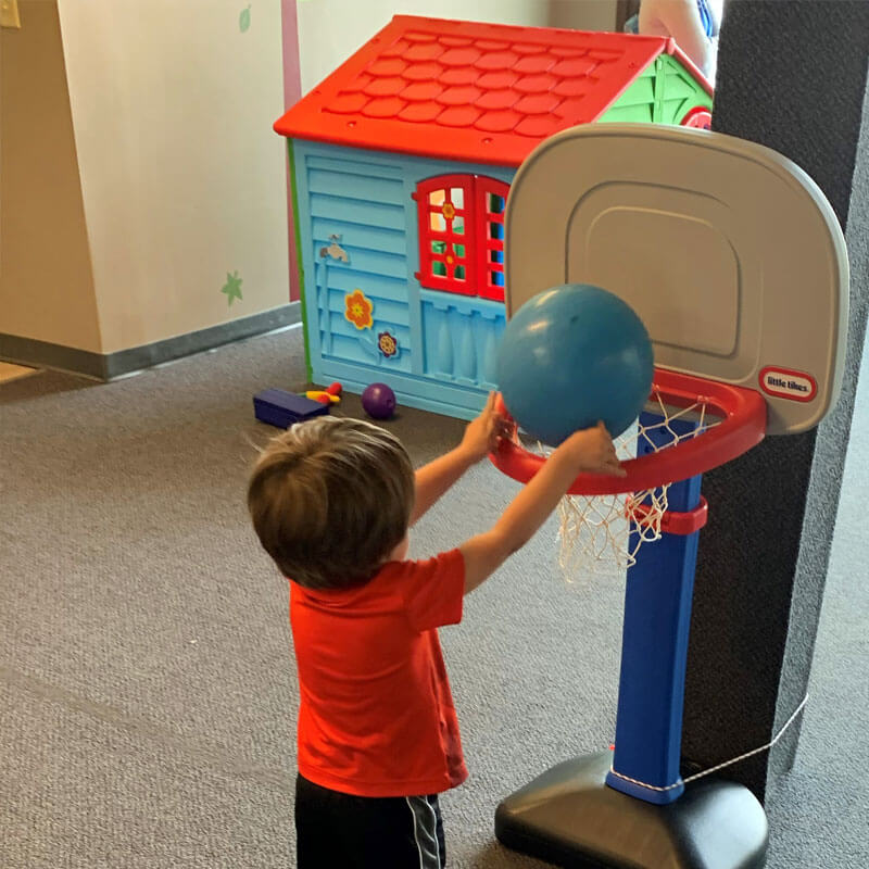 A boy with autism playing basketball