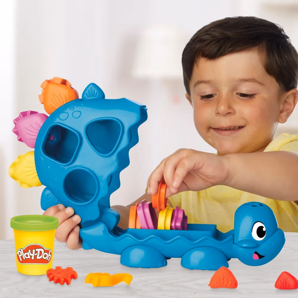 Young child playing with Play-Doh Starters Shapes & Color Dino Playlet